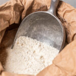 Photo of a shovel in a bag of flour from the Moulin du Vivier