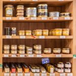 shelf of the Moulin du Vivier shop full of local gourmet products